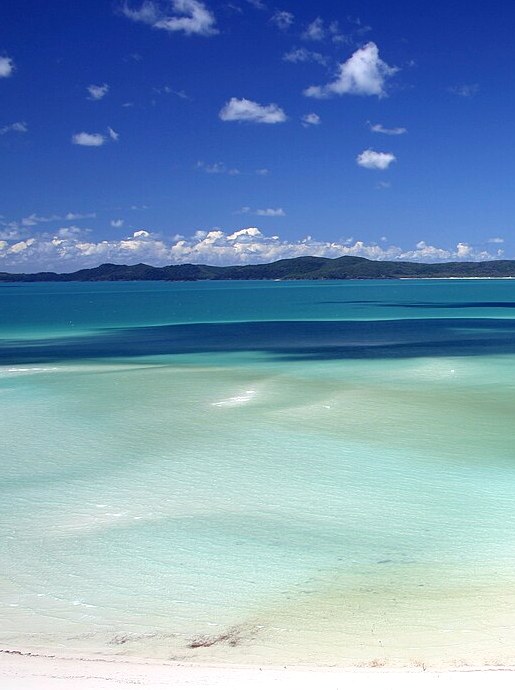 Turquoise sea meeting a bright white-sand shore